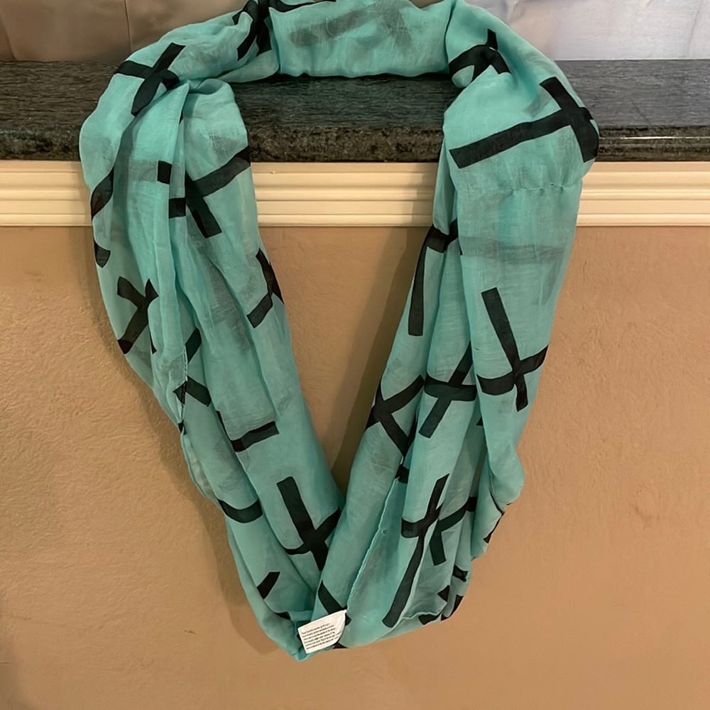 This is a teal and black Paul smith scarf it has lovely crosses all over it.